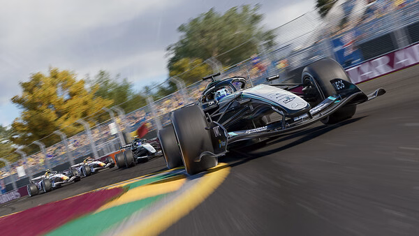 F1 25 screenshot: A race car speeds on a vibrant track, followed by other cars, with trees and spectators in the background.