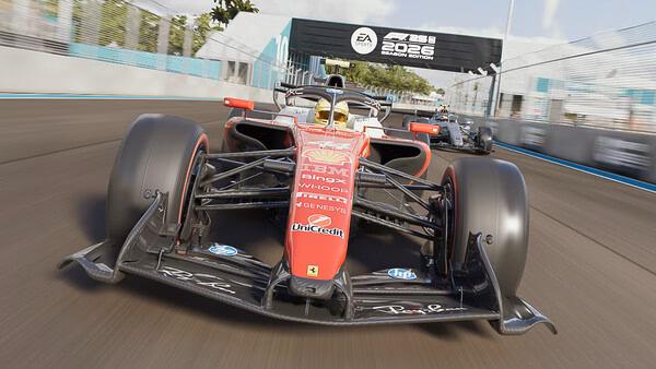 F1 25 screenshot: A red Formula 1 car races on a track with another car behind, under an EA Sports banner.