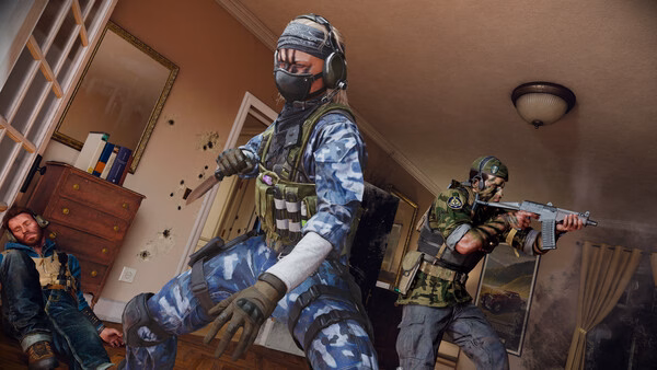 Call of Duty: Black Ops 6 screenshot showing two soldiers in combat gear aiming weapons in a room with a fallen adversary.