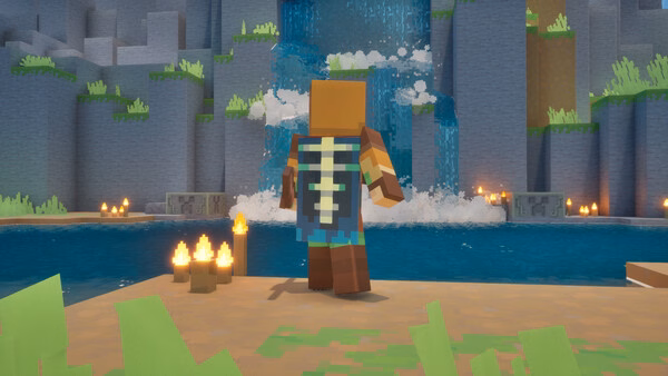 A Minecraft Dungeons II screenshot showing a character standing by a waterfall, surrounded by grass, candles, and a calm pool.