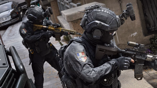 Two armed soldiers in tactical gear patrol an urban street in this Call of Duty®: Modern Warfare® 4 screenshot.